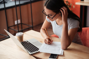 Woman using laptop and researching
